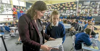  ?? PHOTO: JOHN KIRK-ANDERSON/STUFF ?? Minister for Women Julie Anne Genter is presented with a petition by Maia Devereaux, 10, at Cobham Intermedia­te School.