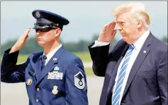  ?? — Reuters photo ?? Trump returns a salute as he steps from Air Force One, en route to nearby Camp David to meet with the National Security Council to try to agree on a strategy for Afghanista­n, in Hagerstown, Maryland.
