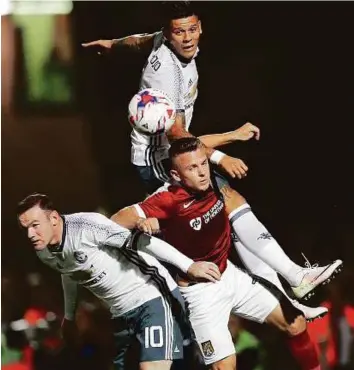  ?? Reuters ?? Manchester United’s Marcos Rojo and Wayne Rooney in action with Northampto­n Town’s Sam Hoskins in the League Cup. United won 3-1