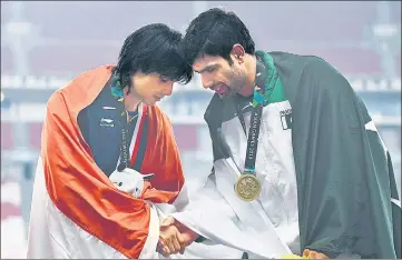  ??  ?? Gold medallist Neeraj Chopra (L) shakes hands with bronze winner Pakistan's Arshad Nadeem at the 2018 Asian Games in Jakarta.