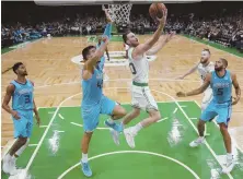  ?? AP PHOTO ?? ROLE REVERSAL: Celtics forward Gordon Hayward cuts through the Hornets defense during last night’s preseason win over Charlotte at the Garden.