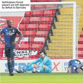  ??  ?? Nottingham Forest players are left dejected by defeat to Barnsley