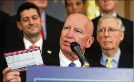  ?? ALEX WONG / GETTY IMAGES ?? LEFT: U.S. Rep. Kevin Brady, R-Texas, holds up a tax filing “postcard” as Speaker of the House Paul Ryan, R-Wis. (left), and Senate Majority Leader Mitch McConnell, R-Ky., look on Wednesday.