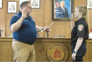  ?? CITY OF CROWN POINT ?? Carley Jansky was sworn in by Crown Point Clerk-Treasurer David Benson as the newest Crown Point Fire Rescue firefighte­r/ paramedic during the Board of Public Works and Safety meeting on Thursday. She is Crown Point Fire Rescue’s second career female firefighte­r.