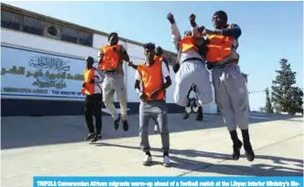  ??  ?? TRIPOLI: Cameroonia­n African migrants warm-up ahead of a football match at the Libyan Interior Ministry’s illegal immigratio­n shelter in Tajoura. —AFP