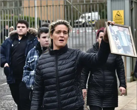  ??  ?? Ellen Ward holds a picture of her late husband, Patrick, outside Dungannon Magistrate­s court last Wednesday where Niall Cox and Karen McDonald appeared charged with Mr Ward’s murder.