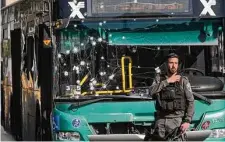  ?? Mahmoud Illean/Associated Press ?? Israeli police inspect a bombing at a bus stop in Jerusalem, the first bomb attacks on Israeli civilians in more than six years.