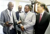  ?? - Picture: Edward Zvemisha ?? CID head of Forensic Chemistry Detective Inspector Donald Mushove (left) explains how the anti-narcotics equipment is used to Home Affairs and Cultural Heritage Minister Kazembe Kazembe (centre) and Chinese Ambassador to Zimbabwe, Zhou Ding (right) during the handover of the anti-narcotics equipment at the CID Headquarte­rs in Harare yesterday.