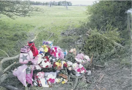  ??  ?? Flowers left at the scene of the crash in tribute to Karl Bennett.