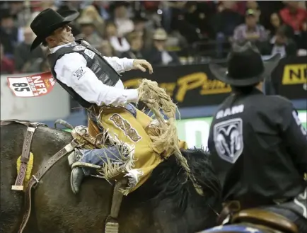  ?? Chase Stevens Las Vegas Review-journal @csstevensp­hoto ?? Joey Sonnier, of New Iberia, La., rides Happy Valley in saddle bronc competitio­n Friday during the second go-round of the National Finals Rodeo at the Thomas &amp; Mack Center.