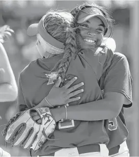  ?? Jerry Baker ?? Atascocita pitcher Tierrah Williams, right, shares a hug with third baseman Sarah Cedillo after their 4-3 victory over Pearland Dawson on Saturday.