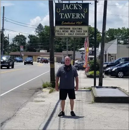  ?? ALEX ROSE - MEDIANEWS GROUP ?? Jack’s Tavern owner Jerry McArdle stands under the sign for his Media business.