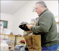  ?? Lynn Atkins/The Weekly Vista ?? Collecter Jay Williams shows off a German WWI-era helmet at the Bella Vista History Museum on Saturday.