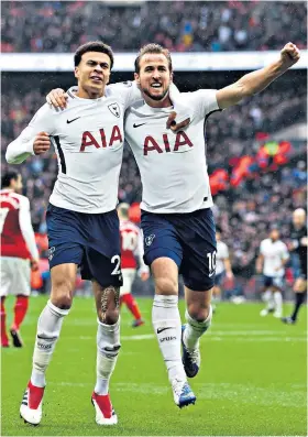  ??  ?? Home comforts: Harry Kane celebrates with Dele Alli (left) after scoring against Arsenal at Wembley