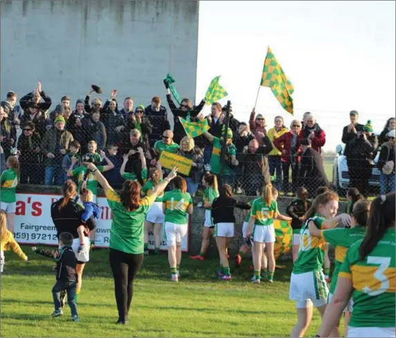  ??  ?? Tourlestra­ne players and supporters show their elation at the full-time whistle in Bagenalsto­wn as they prepare for the All-Ireland Junior final, only the 3rd time a Sligo reached this stage. Pic: KeithGilro­y.