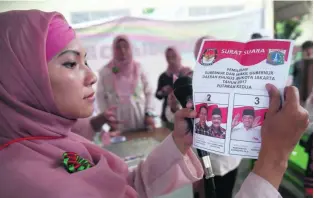  ?? Adi Weda / EPA ?? Election workers count ballots at a polling station in Jakarta, Indonesia.