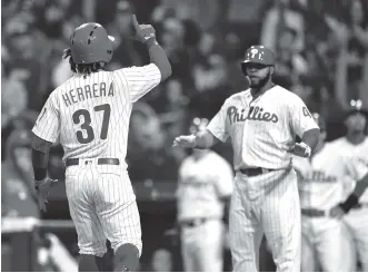  ?? THE ASSOCIATED PRESS ?? The Phillies' Odubel Herrera (37) celebrates after hitting a three-run home run off the Atlanta Braves' Julio Teheran during the first inning of Friday night's game in Philadelph­ia.