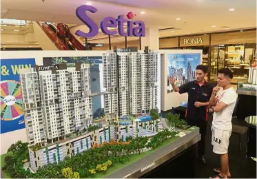  ??  ?? On the rise:A visitor looking at the Setia Skyvista project models during the StarProper­ty.my Fair 2018 at Queensbay Mall in Penang.