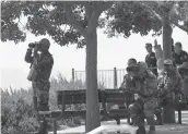  ?? — AFP ?? UN soldiers observe Syria’s Quneitra province at an observatio­n point near the border with Syria on Monday.