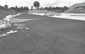  ?? PHOTOS BY JASON BEAN/USA TODAY NETWORK ?? The University of Nevada, Reno’s freezing cold winters have caused cracks, potholes and icy puddles in the university’s track, shown here in 2016. The track was resurfaced later that year and repaired again six years later.