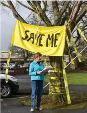  ?? ?? BBSCRA secretary Kerry Elliot reads a statement about the removal of the Golden elm on Friday morning.