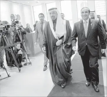  ?? Joe Klamar AFP/Getty Images ?? SAUDI ENERGY MINISTER Khalid al-Falih, center, arrives for a meeting at OPEC’s Vienna headquarte­rs. Saudi Arabia, OPEC’s dominant member, agreed to cut its oil production by about 500,000 barrels a day.