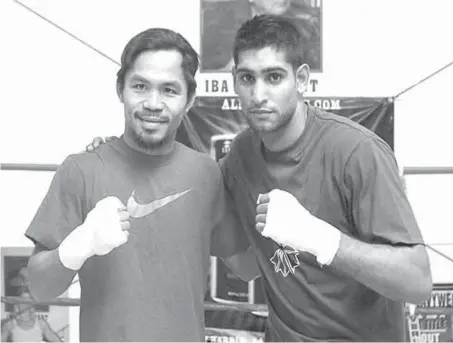  ?? PHILSTAR FILE PHOTO ?? Former British boxing champ Amir Khan (right) still hopes that he can get a chance to face Manny Pacquiao this year.