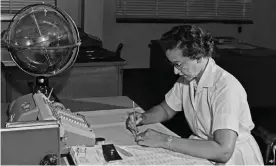  ??  ?? Katherine Johnson with an adding machine and a ‘celestial training device’ at her desk at Nasa’s Langley research centre in 1962. Photograph: Donaldson Collection/Getty Images