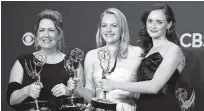  ?? THE ASSOCIATED PRESS ?? Ann Dowd, left, winner of outstandin­g supporting actress in a drama series, Elisabeth Moss, middle, winner of outstandin­g lead actress in a drama series, and Alexis Bledel, winner of outstandin­g guest actress in a drama for “The Handmaid’s Tale,” pose...