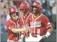  ?? (NWA Democrat-Gazette/Charlie Kaijo) ?? Cayden Wallace (from left), Jace Bohrofen and Jalen Battles celebrate a run during the fourth inning of Saturday’s game against Vanderbilt at Baum-Walker Stadium in Fayettevil­le. The game was suspended because of weather in the sixth inning with Arkansas ahead 8-6 and is set to resume at 11 a.m. today. More photos at arkansason­line.com/515vandyua/