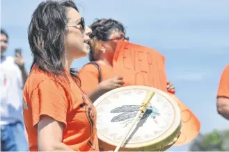  ?? TINA COMEAU ?? Melanie Robinson-Purdy joined others in drumming and performing the Honour Song as part of a walk of remembranc­e by the Acadia First Nation and community members on Canada Day in honour of the children of residentia­l schools.