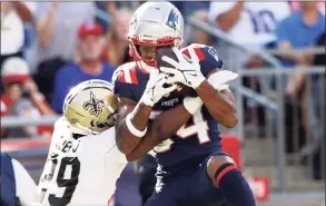  ?? Elsa / Getty Images ?? The Patriots’ Kendrick Bourne (84) makes the catch and runs it in for a touchdown as the Saints’ Paulson Adebo defends in the fourth quarter on Sunday in Foxborough, Mass.