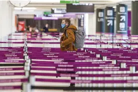  ?? ?? LONELY JOURNEY: A single passenger in an Edinburgh airport desk queue