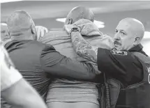  ?? Derek Gee/associated Press ?? Court officers restrain a man who lunged toward the defendant, Payton Gendron, a white supremacis­t who killed 10 Black people at a supermarke­t last year in Buffalo, N.Y.