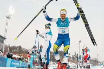  ?? THE ASSOCIATED PRESS ?? Sweden’s Charlotte Kalla celebrates after winning the gold medal in the women’s 15-kilometer skiathlon cross-country skiing competitio­n Saturday at the 2018 Winter Olympics in Pyeongchan­g, South Korea.