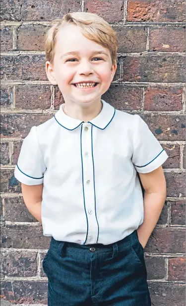  ??  ?? Prince George, five today, grins for an official royal photo taken at Clarence House