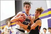  ?? MICHAEL COOPER / CONTRIBUTE­D ?? Emmanuel Christian Academy’s Noah Willis and Dayton Christian’s Devin Drier battle for the basketball during a Metro Buckeye Conference showdown Friday night in Springfiel­d. The Lions won 49-40 to remain tied for first with Troy Christian.