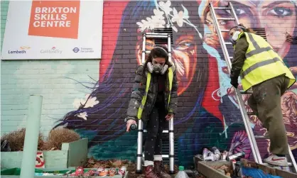  ??  ?? Alba Bernal and Vicky Lim, members of the Wom Collective, work on a mural in Brixton, London, to celebrate Internatio­nal Women’s Day. Photograph: Niklas Halle’n/AFP/Getty Images