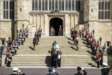  ?? RICHARD POHLE — POOL VIA AP ?? The coffin is carried into St. George’s chapel during the procession ahead of Britain Prince Philip’s funeral in Windsor Castle, Windsor, England, on Saturday. Prince Philip died April 9 at the age of 99 after 73 years of marriage to Britain’s Queen Elizabeth II.