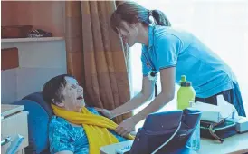  ??  ?? HELPING HAND: SwanCare RN Marie Wang catches up with resident Pauline Best