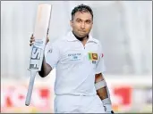  ??  ?? Mahela Jayawarden­e celebrates after scoring a double century against Bangladesh during the third day of their first test cricket - REUTERS