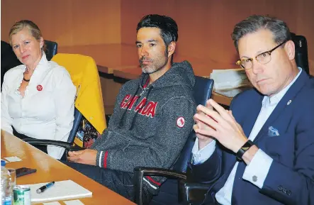  ?? AL CHAREST ?? Brian McKeever, Canada’s most decorated Winter Paralympia­n of all time, centre, is flanked by Calgary 2026 CEO Mary Moran and board chair Scott Hutcheson as he chats with Postmedia editors and journalist­s about how the 1988 Olympic Games changed his life forever.