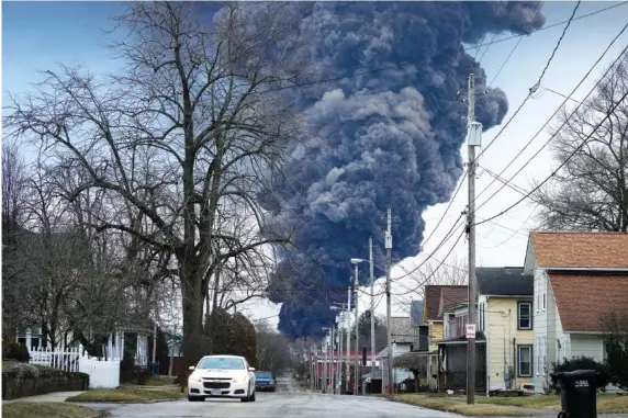  ?? AP PHOTO/GENE J. PUSKAR ?? On Feb. 6, a black plume rises over East Palestine, Ohio, as a result of a controlled detonation of a portion of the derailed Norfolk Southern trains.