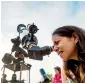  ?? AFP ?? A woman observes the sky through a telescope during a tour at the Astronomic Centre in Colina near Santiago in Chili. —