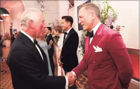  ?? Chris Jackson / AP ?? Britain’s Prince Charles, left, meets some of the cast including actor Daniel Craig, right, at the world premiere of the new James Bond film “No Time To Die” at Royal Albert Hall in London.