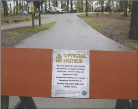  ?? The Sentinel-Record/Richard Rasmussen ?? CAMPING LIMITATION­S: A sign blocks an entrance to the tent-only camping area at Lake Catherine State Park Tuesday.