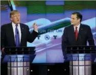  ?? THE ASSOCIATED PRESS ?? Sen. Ted Cruz, R-Texas, right, listens as Donald Trump speaks during a Republican presidenti­al primary debate Feb. 25 at The University of Houston in Houston.