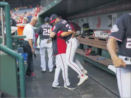  ?? PABLO MARTINEZ MONSIVAIS - THE ASSOCIATED PRESS ?? In this May 4, 2018, photo, Washington Nationals Bryce Harper is hugged and lifted off the ground by his manager Dave Martinez in the dugout prior to the start of a baseball game against the Philadelph­ia Phillies at Nationals Park in Washington.