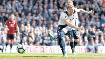  ?? REUTERS ?? Tottenham’s Harry Kane scores their third goal against Bournemout­h.