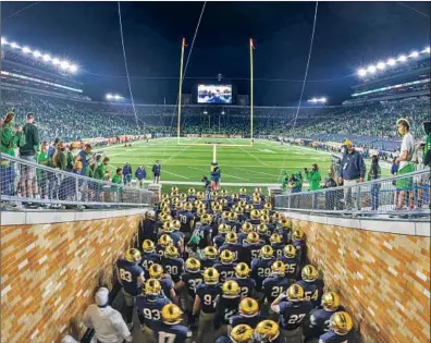  ?? Matt Cashore Associated Press ?? NOTRE DAME PLAYERS gather in the tunnel before facing Clemson on Nov. 7 at South Bend, Ind. The Irish’s upset triggered a rush onto the field by fans, and there was a slight bump in COVID-19 cases the week after the game.